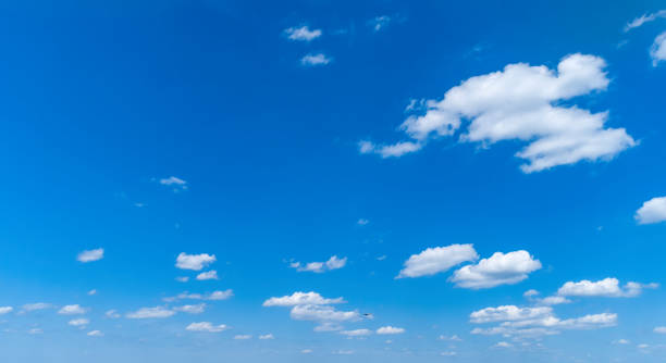 istock White Fluffy Clouds Floating in the Bright Blue Skies 1171493822