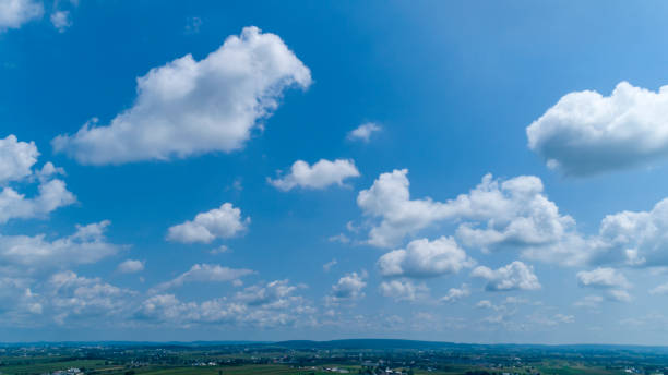 istock White Fluffy Clouds Floating in the Bright Blue Skies 1171493877
