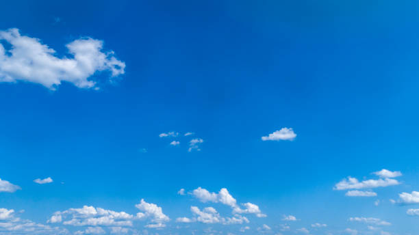 istock White Fluffy Clouds Floating in the Bright Blue Skies 1171494573