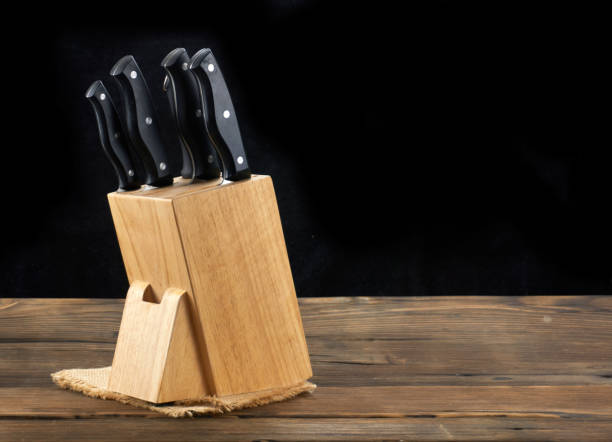 istock knife isolated on wood background. 1171494606