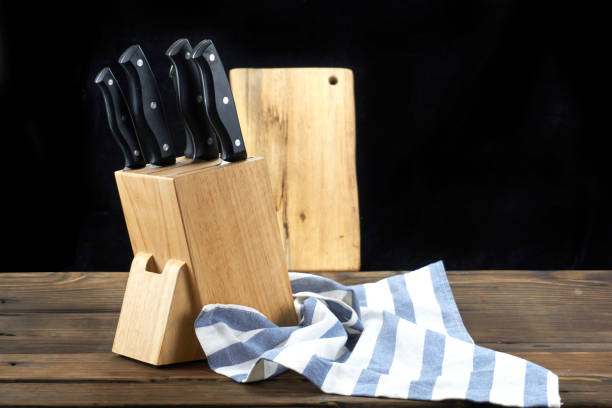 istock knife isolated on wood background. 1171494631