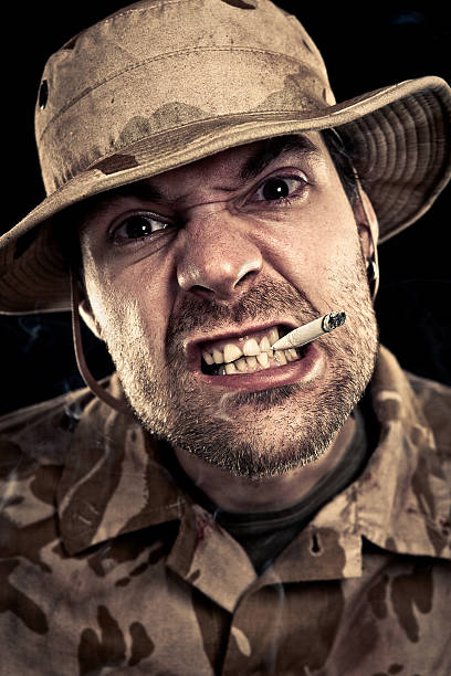 istock Military Soldier Smoking A Cigarette While Sneering 117149472