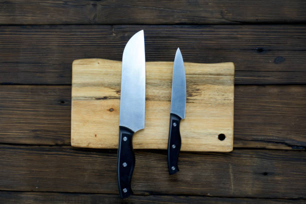 istock knife isolated on wood background. 1171494777
