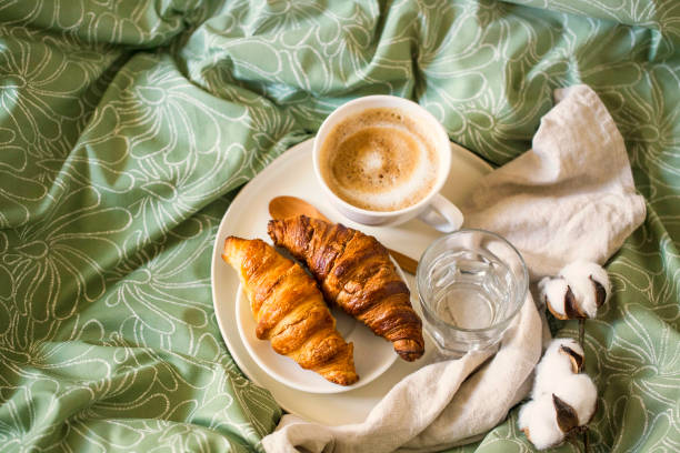 istock Morning breakfast with coffee cup and croissants in bed. Top view 1171494791