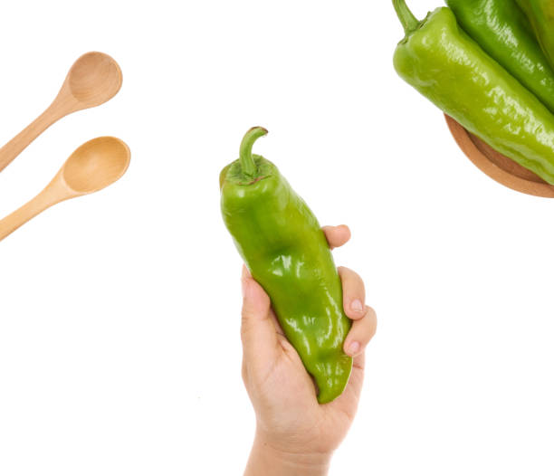 istock Female hand holding Fresh green pepper on white background 1171494985
