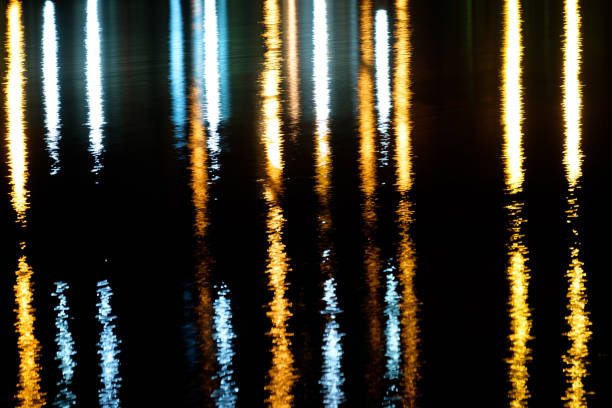istock vertical strips of reflected light at night on water 1171495184