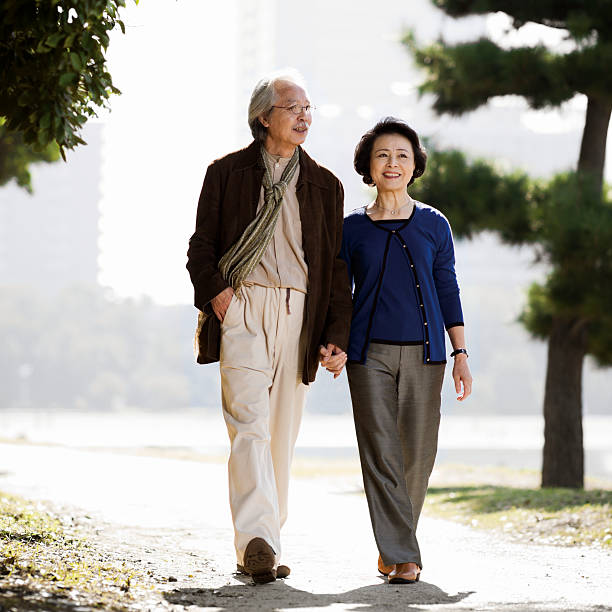 istock Senior Asian Couple Holding Hands in Park 117149575