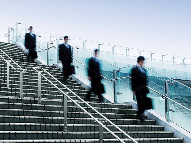 istock Businessmen Walking Down a Flight of Stairs 117149614