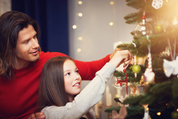 istock Beautiful family decorating Christmas tree at home 1171496301