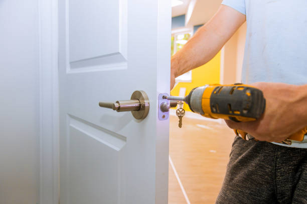 istock Carpenter at lock installation with wood door 1171496487