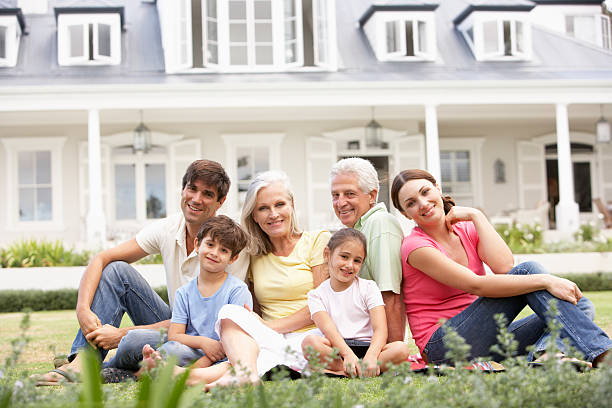 istock Extended Family Sitting Outside House On Lawn 117149755