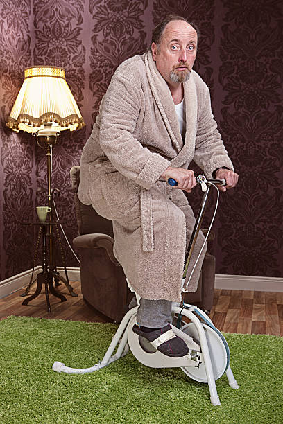 mature man exercising Mature man exercising on an old fashioned exercise  bikeMature man exercising on an old fashioned exercise  bike choir photos stock pictures, royalty-free photos & images