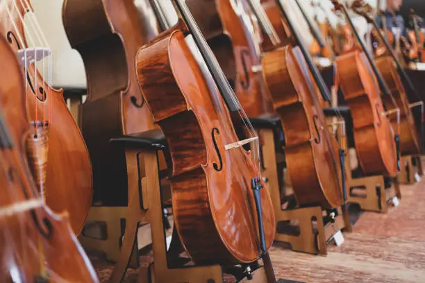 Photo of Details with parts of violins before a symphonic classical concert