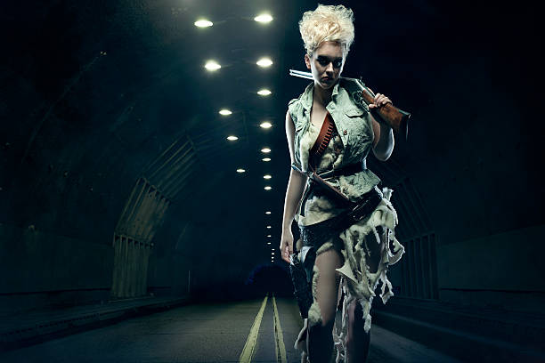 Post Apocalyptic Woman in Dark Tunnel A woman in ragged clothes and animal furs stands in a futuristic smoke filled tunnel, the result of natural causes, or nuclear holocaust... steampunk pistol pictures stock pictures, royalty-free photos & images