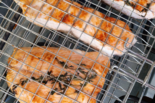 grilled salmon fish on grid close-up. salmon fillet on grill. healthy eating. - main course salmon meal course imagens e fotografias de stock