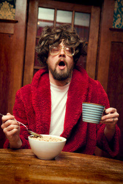 istock Tired Nerd Man Eating Cereal and Yawning 117150424