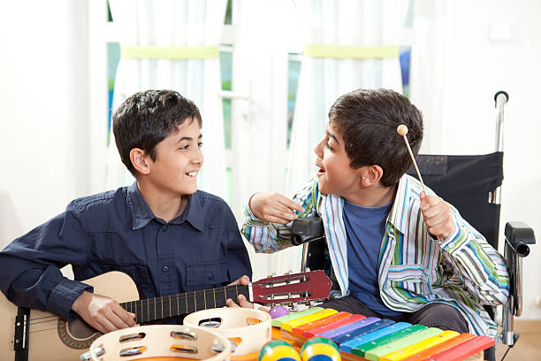Musical Therapy Disabled little boy in a music class. music therapy child stock pictures, royalty-free photos & images
