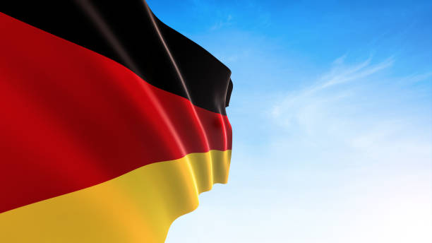 istock Germany flag waving in blue sky 1171506363