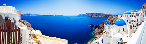 Santorini caldera with famous churches (XXXL panorama) Panorama of Santorini caldera with famous Orthodox churches with blue domes in village Oia (Ia). XXXL wide panorama, stitched from 8 images Canon 5DMkII. Click for more images: http://santoriniphoto.com/Template-Greek.jpg santorin stock pictures, royalty-free photos & images