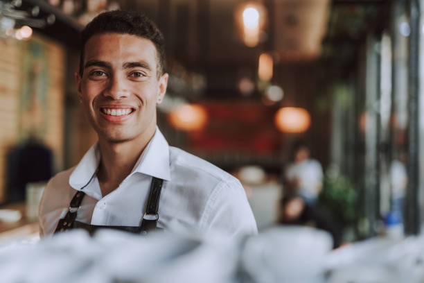istock Joyful young man in white shirt standing against blurred background 1171507845