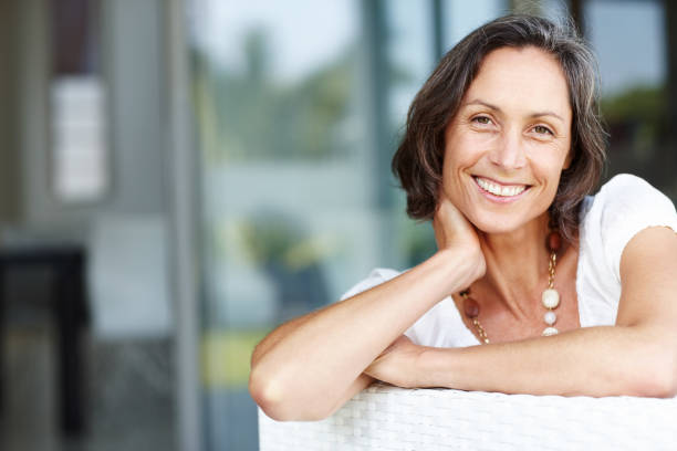 istock Cheerful mature woman relaxing on a couch 117150804