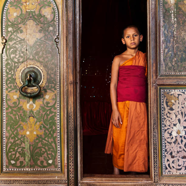Photo of budhist monk in a temple.