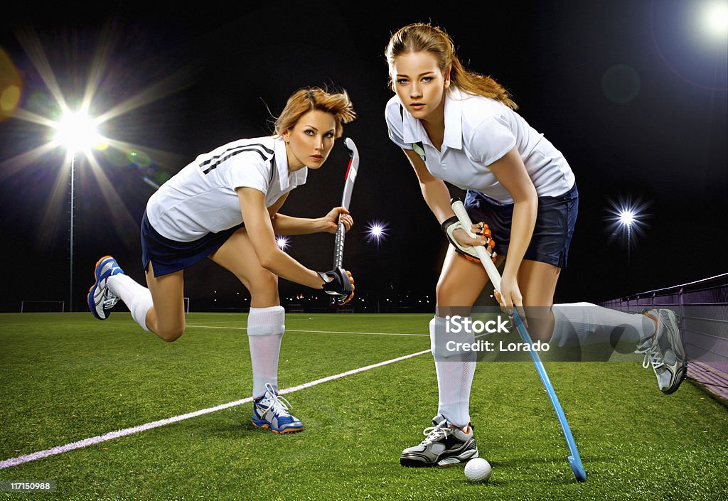 two women playing field hockey Field Hockey Stock Photo