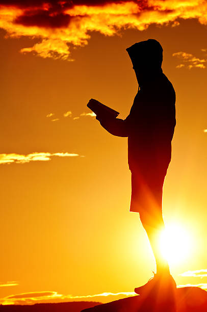 istock Reading Bible in the dramatic sunset - II 117151030