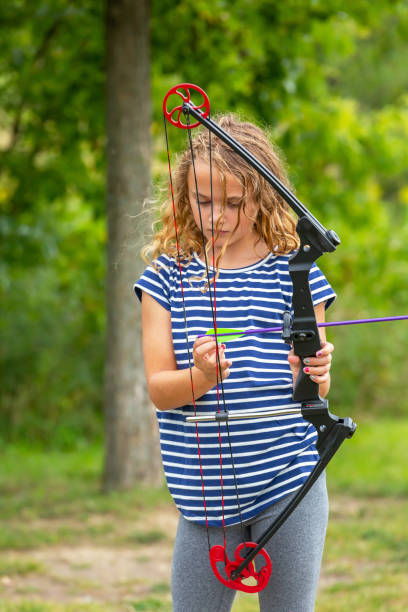 istock Young Girl Practicing Archery at Outdoor Shooting Range 1171510322