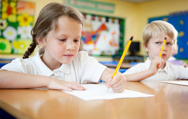 primary school: children concentrating on schoolwork. stock photo