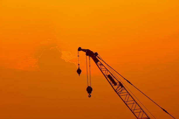 istock Silhouette Crane in building construction site. 1171511353