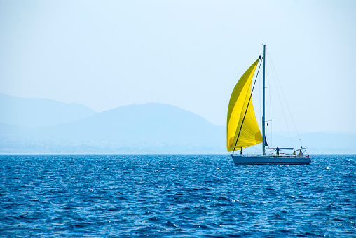 Sailing with yellow spinnaker on the sea