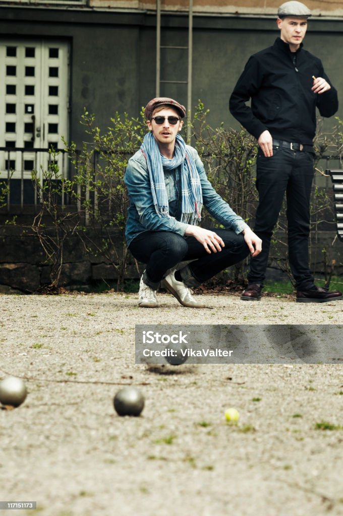 Petanque game Two young Finnish men playing petanque in the neighbourhood park in Helsinki Boules Stock Photo