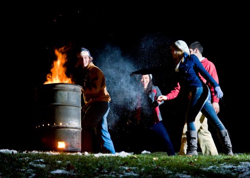 These charming All-American looking young adults were enjoying a warm campfire in a 50 gallon barrel when they broke out into a playful snowball fight.