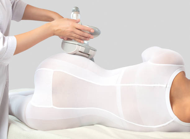 The masseur make an  hardware anti-cellulite lpg massage in a beauty salon. The masseur make an  hardware anti-cellulite lpg massage in a beauty salon. liquefied petroleum gas photos stock pictures, royalty-free photos & images