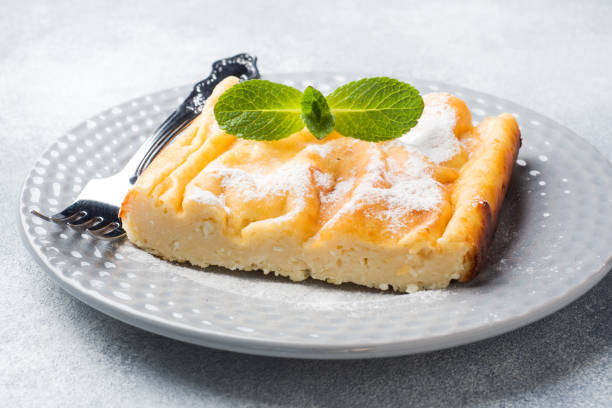istock Cottage cheese casserole on a plate with powdered sugar and mint leaves. Selective focus 1171513394