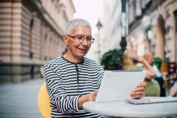istock Senior woman working from cafe 1171513436