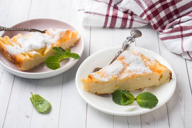 istock Cottage cheese casserole on a plate with powdered sugar and mint leaves. Selective focus 1171514343