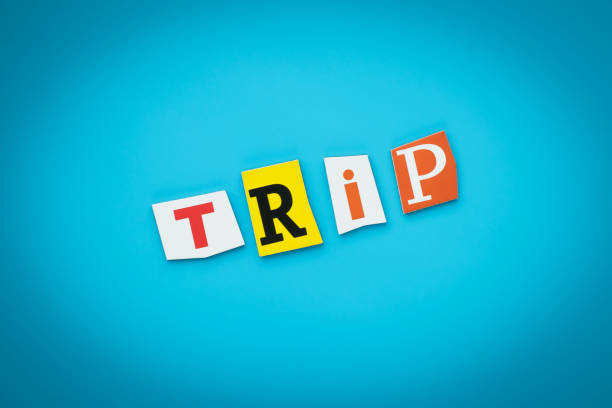istock Single word - trip. Text on blue background from colorful letters. Message on poster. Headline on card. Multicolored inscription on card, banner. Travel concept. 1171516115