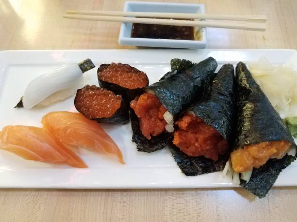 istock squid, salmon, salmon eggs, and sushi rolls 1171518646
