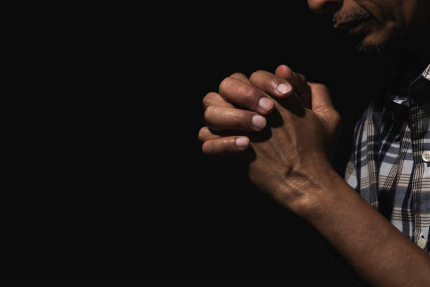 istock Hand of man while praying for religion. Concept peace and life. 1171520209