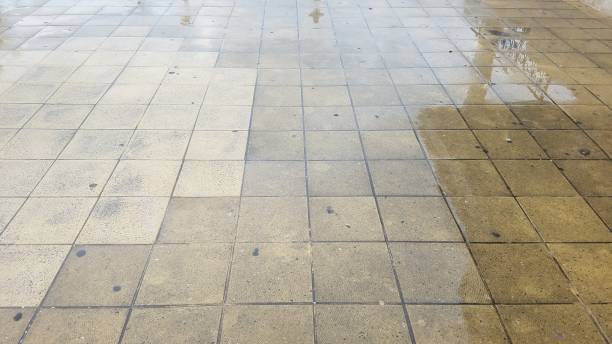 istock wet grey square floor tiles on ground 1171521678