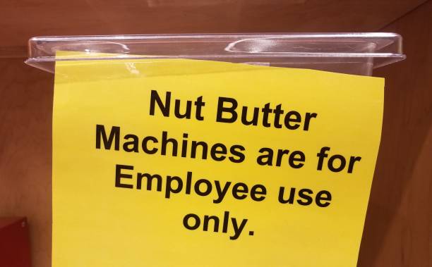 istock yellow nut butter machines are for employee use only sign on plastic container 1171524095