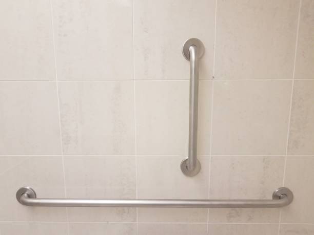 istock metal railings on tan bathroom tile wall 1171524125