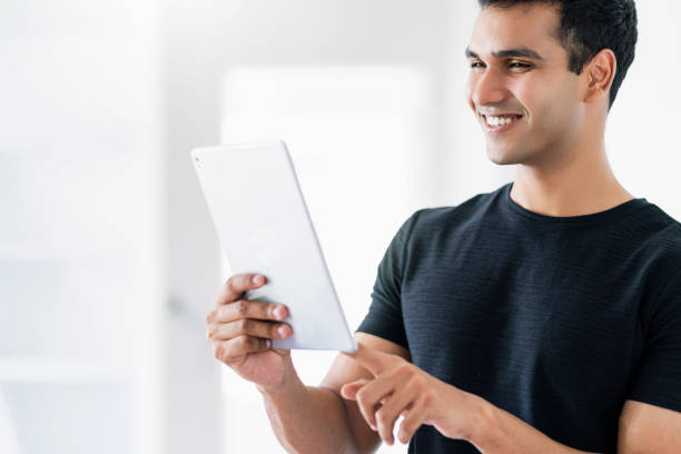 istock smart attractive indian man hand use tablet with happiness and joyful business communication technology ideas concept 1171524219
