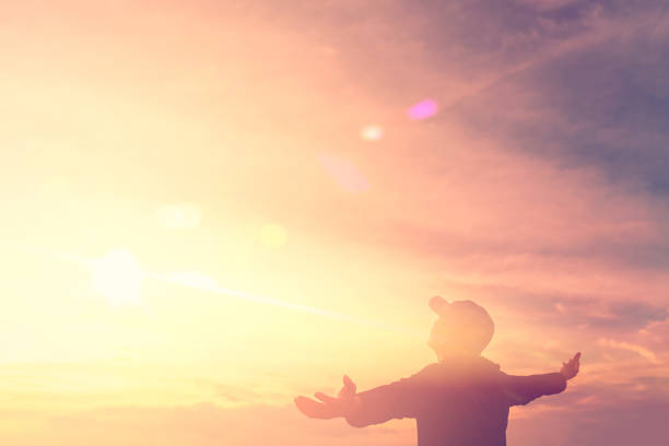 istock Man hand raise on sunset sky background. 1171525015