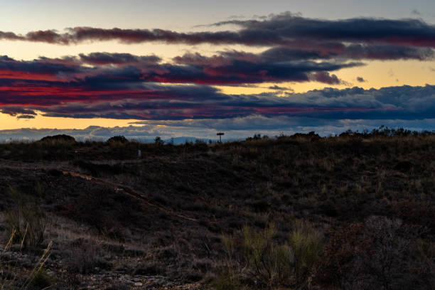 istock Sunset in the countryside, with red clouds and a direction arrow. 1171525894