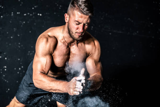 istock Young muscular man with big sweaty muscles doing push ups workout training with clap his hand above the barbell weight plate on the gym floor with motion blur 1171528381