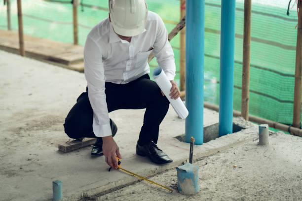 Engineer checking defect in construction site measure offset distance of sleeve of soil pvc pipe stock photo