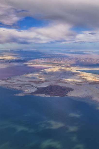 Great Salt Lake Utah Aerial view from airplane looking toward Oquirrh Mountains and Antelope Island, Tooele, Magna, with sweeping cloudscape. United States. Great Salt Lake Utah Aerial view from airplane looking toward Oquirrh Mountains and Antelope Island, Tooele, Magna, with sweeping cloudscape. United States. tooele stock pictures, royalty-free photos & images